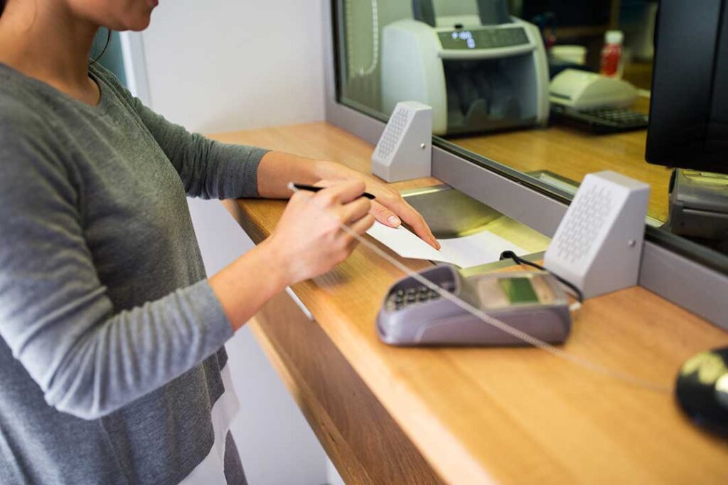 Couple reviewing retirement account statements and tax documents at a kitchen table.